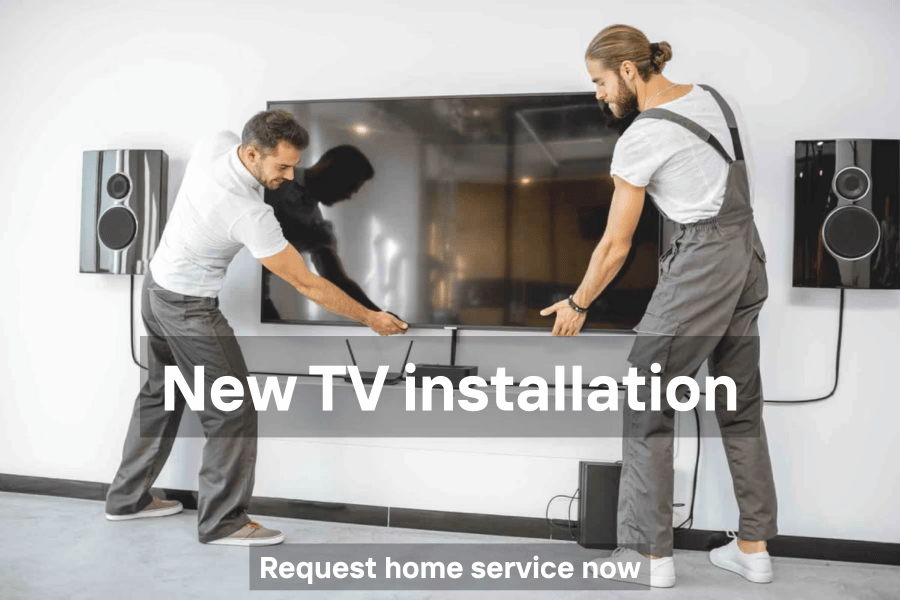 Technician installing a new TV on the wall or stand at home