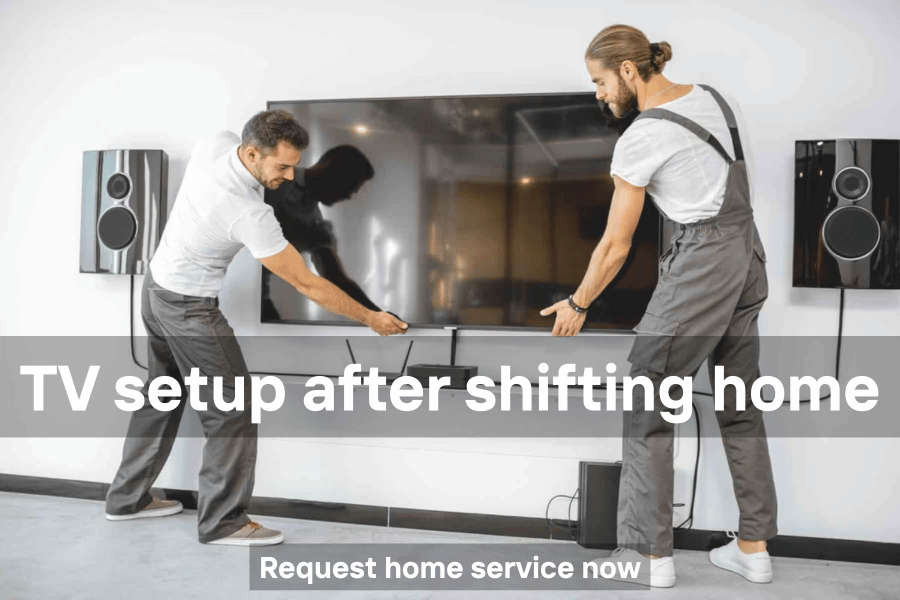 Technician setting up a TV in a new home after relocation