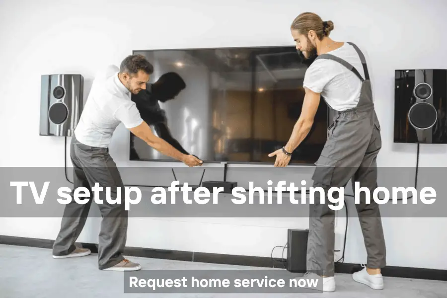 Technician setting up a TV in a new home after relocation