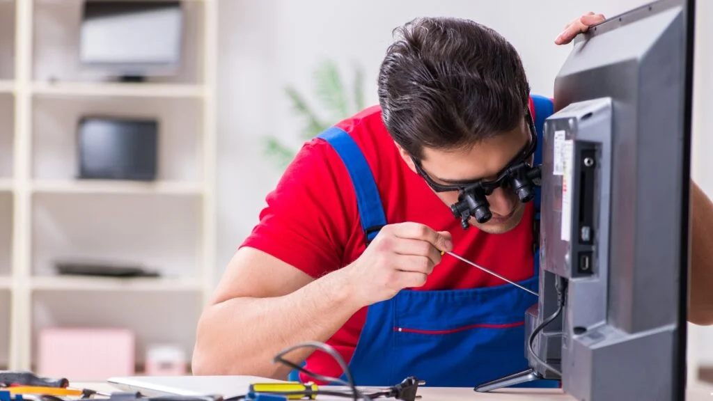 TV repair near me — Riyadh Electronics certified technician inspecting a Smart TV panel