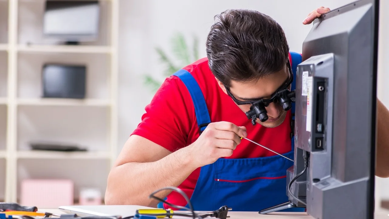 TV repair near me — Riyadh Electronics certified technician inspecting a Smart TV panel